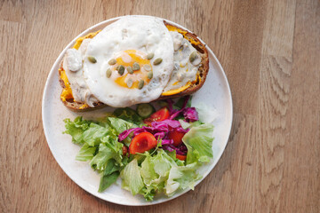top view of Egg and mushrooms on toast served with fresh salad on a plate 