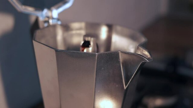 Espresso Coffee boiling from Italian coffe maker Moka Pot. Close-up