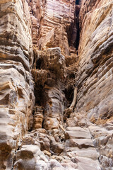 Fototapeta na wymiar Large bird nests in rock crevices at end of the Mujib River Canyon tourist route in Wadi al-Mujib in Jordan