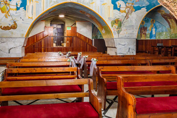 Wooden benches in main hall of the Greek Orthodox Church of Annunciation in Nazareth old city in...