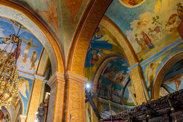 Fototapeta na wymiar Pillar wall and ceiling painted with religious themes in the main hall of Greek Orthodox Church of Annunciation in the Nazareth old city in northern Israel