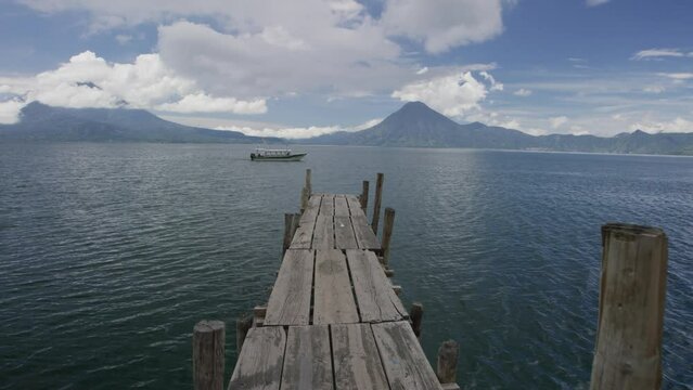 Old, narrow dock at Guatemala lake - steady cam wide shot