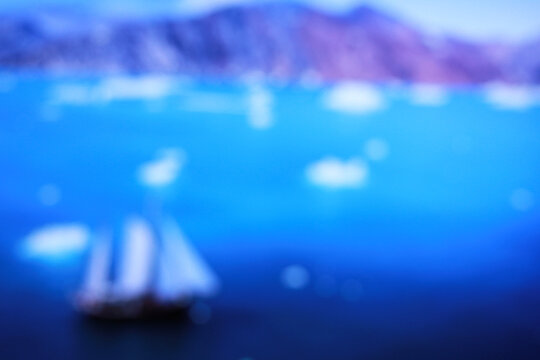 Blurry image of sailboats anchored in a bay of the island