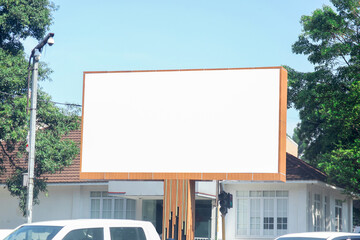 Outdoor pole billboard on blue sky background with mock up white screen and clipping path
