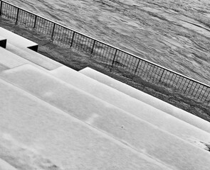 the river level rises and floods the snowy stairs