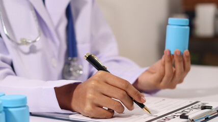 Initial AI illustration of a close-up of a female doctor's hand signing a medical document on a clipboard. and recommending certain medicines to patients on a laptop