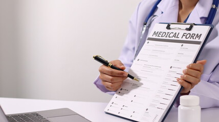 Initial AI illustration of a close-up of a female doctor's hand signing a medical document on a...