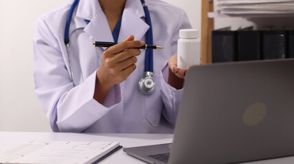 Initial AI illustration of a close-up of a female doctor's hand signing a medical document on a...
