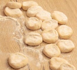 Fototapeta na wymiar Dough for dumplings on a wooden table
