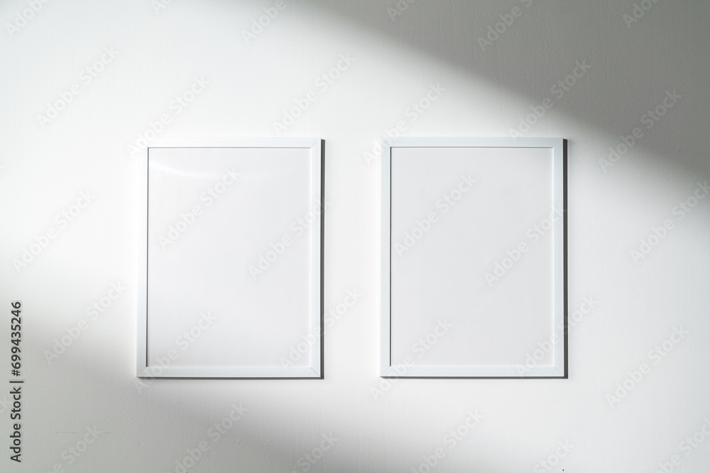 Wall mural Blank picture frames on the white wall copy space