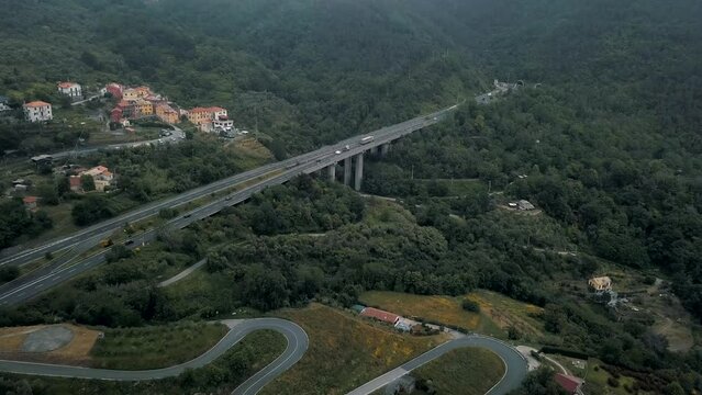 The lush canopy in Moneglia parts to reveal a highway that crosses one of the valleys make up the Italian landscape
