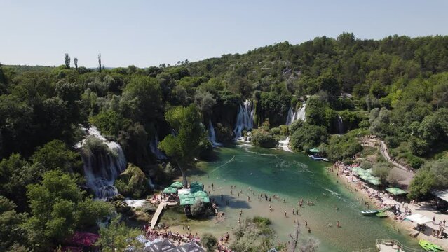 Drone flyover Crowded tourist area of Kravica waterfall, Scenic landscape in Bosnia and Herzegovina