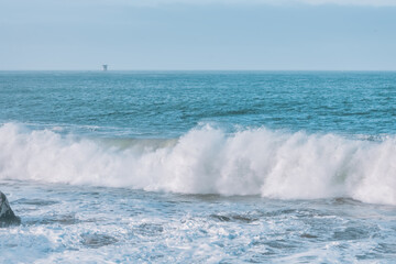 Wave splashing close-up. Crystal clear sea water, in the ocean in San Francisco Bay, blue water, pastel colors.
