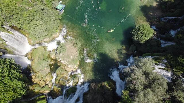 Topdown view of mesmerizing Kravica Waterfall with emerald-colored water, Tilt up Shot. Bosnia and Herzegovina