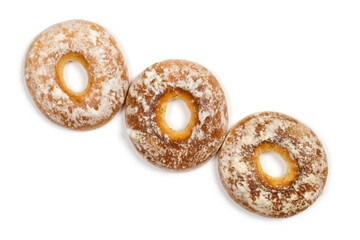 Three gingerbread cakes with a hole. Bagels on a white background, top view. Sweet confectionery.