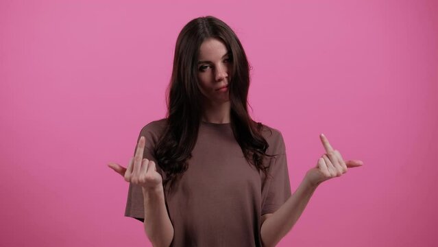 Young woman showing middle finger, gesture of fuck off. Young girl shows a gesture of fuck. Expression negative, aggression, provocation. Emotions. People. Lifestyle. High quality 4k footage