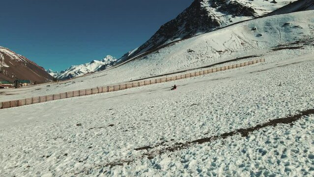 Thrilling descent down snow-covered Andean peaks with a jul&eacute; patin, blending adventure and scenic splendor in the heart of the mountains.