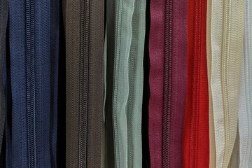 Fotobehang Plastic zippers of different colors. Assorted YKK nylon zippers. The hottest colors of the season. © Igor