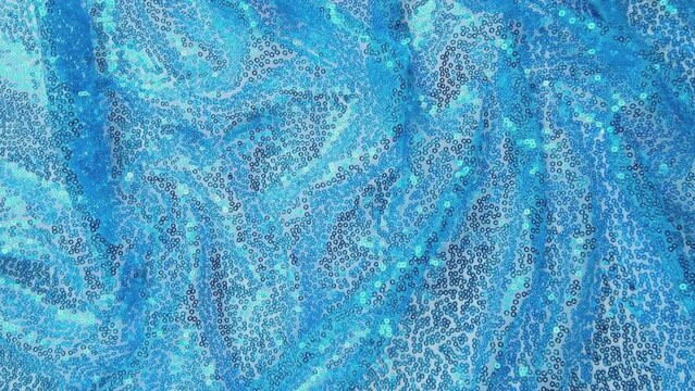 Blue sequins background - abstract festive backdrop for Holiday and party banner. Glamor shiny background with sequin texture.