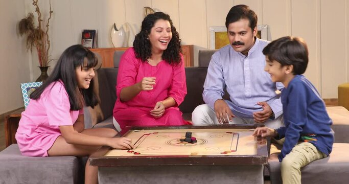 Video of Happy family playing carrom together at home
