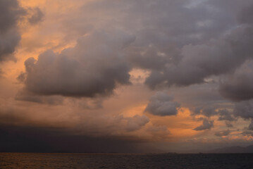Naklejka na ściany i meble Vibrant Sunset Cloudscape Over Sea
