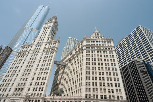 Iconic Wrigley Building and Modern Skyscrapers Against Chicago's Blue Sky