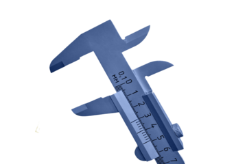 A large open caliper on a background of yellow wall, isolated on a white background