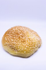 Sesame bun side view food photography close up on isolated white background
