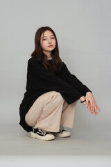 Teen in a plain top, her subdued demeanor highlighting the emotional depth and contemplative...