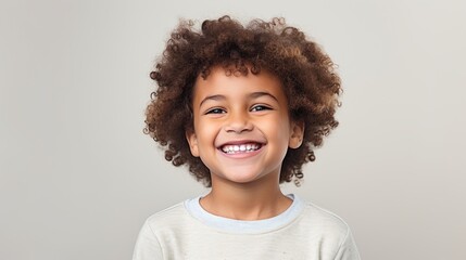 A professional portrait studio photo of a cute mixed race boy child model with perfect clean teeth laughing and smiling. isolated on white background