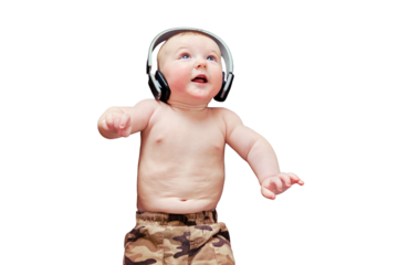 Funny happy baby boy listens to music in wireless headphones online from his phone. Smiling child is lying in earphones, isolated on a white background
