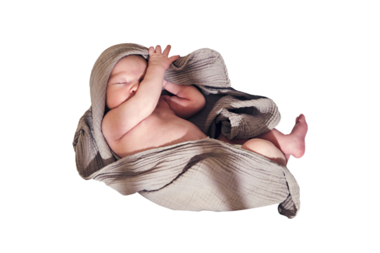 A newborn baby sleeps in a crib with a cocoon and a blanket in the form of a turban on his head, isolated on a white background. Kid age 0 months