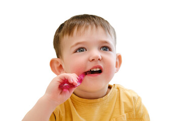 A child is brushing his teeth before bed in the safety of his crib, isolated on white background. Kid aged about two years (one year eleven months)