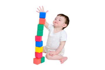 Happy baby play educational toys on studio, isolated on white background. Portrait of a smiling child playing while sitting on the floor. Kid about two years old (one year nine months)