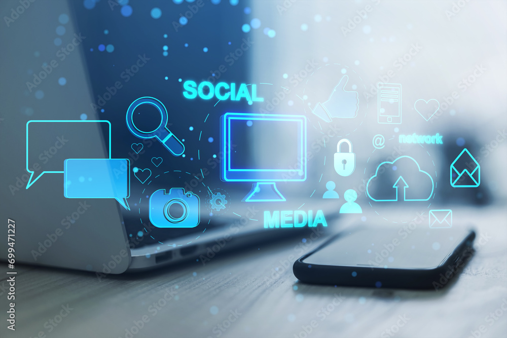 Poster close up of laptop on desk with smartphone and creative social media interface with emails, speech b