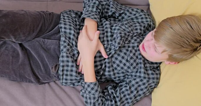 Little boy suffering from stomachache at home.The child has a stomach ache.