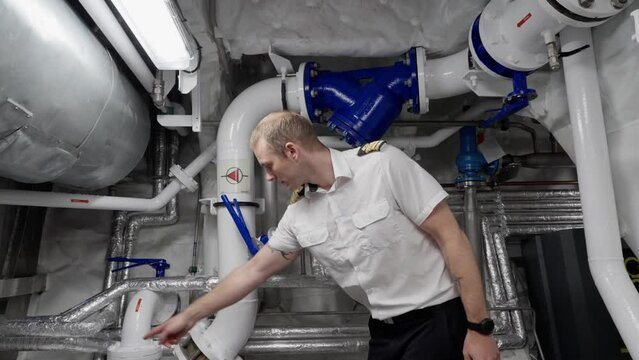 Captain show piping for ship`s fire fighting system, sprinkler and deluge in engine room