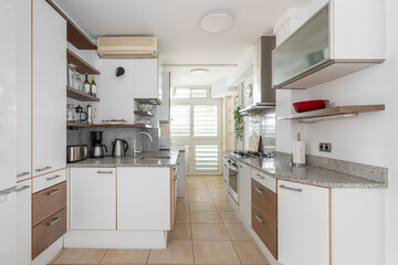 Fototapeta premium Kitchen zone equipped with cooking appliances and furniture