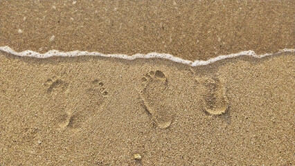 Footprints of a husband and wife on the white sand of the beach. Simple romantic holiday background concept