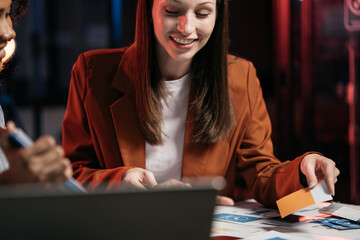 Creative female web designer planning application development for web mobile phone at modern...