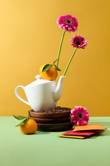 A stack of few wooden dishes with a teapot placed on top. Pink flowers featured with red and yellow envelopes. Concept of Happy Chinese New Year festival