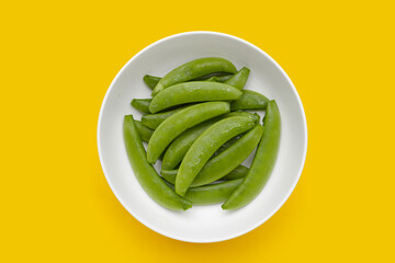 Fresh young green peas on white background.