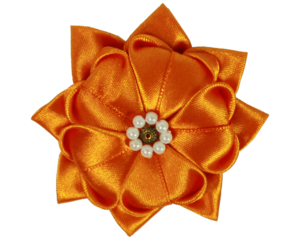 orange fabric brooch made of satin ribbon without background 