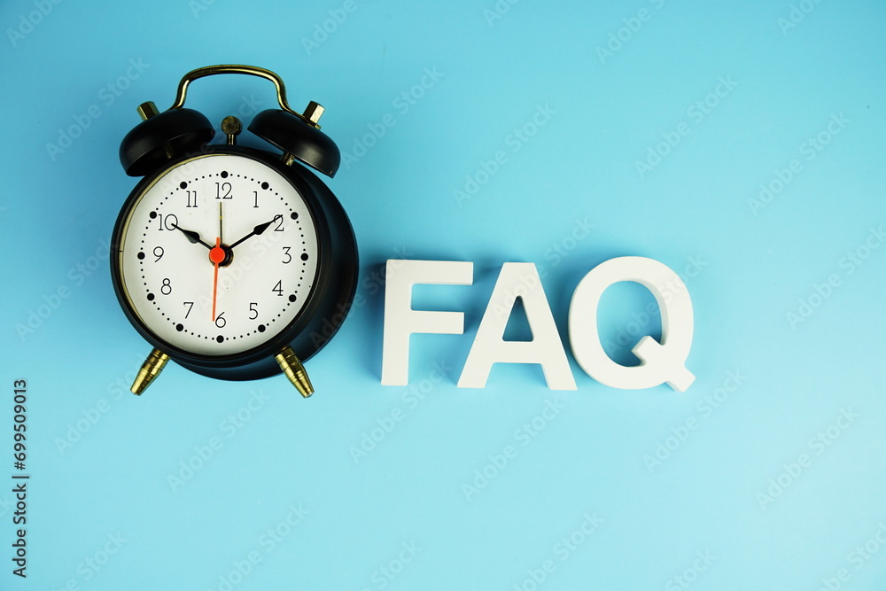 Poster faq alphabet letters with alarm clock top view on blue background