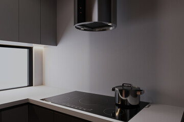A kettle on the Electric stove on the kitchen counter with a kitchen hood in a modern kitchen.