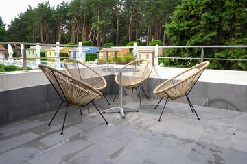 Fototapeta premium Balcony of a country cottage with a metal table and chairs.