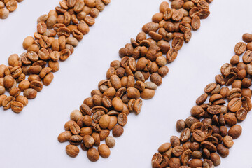 Various stages roasting of coffee beans showing from green through to brown italian roast, top view