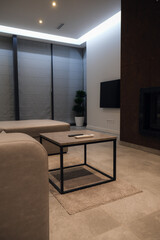 Living room design. Coffee table with remote controls for equipment.