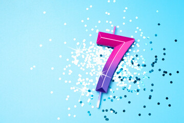 7 years celebration festive background made with colorful candle in the form of number Seven lying...