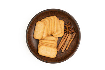 Cookies and spices in a plate on a white background